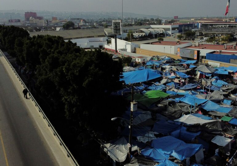 Some 22,000 migrants wait in shelters and makeshift camps in three cities in Mexico